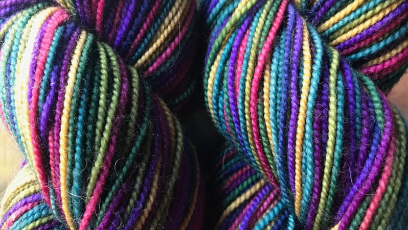 Colorful hand-painted skeins of yarn by Abstract Fiber.